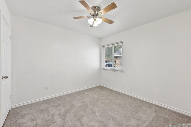 empty room featuring carpet floors, a ceiling fan, and baseboards