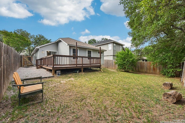 rear view of house with a lawn, a fenced backyard, and a wooden deck
