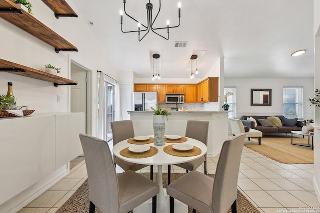 dining space featuring a notable chandelier, visible vents, and light tile patterned floors