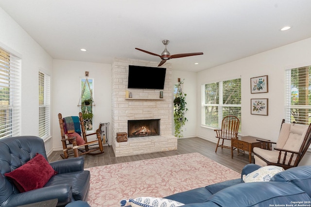 1420 Persimmon Pass, Fischer, TX 78623 - living room with recessed lighting, ceiling fan, a stone fireplace, and wood finished floors