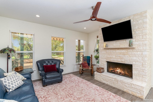 1420 Persimmon Pass, Fischer, TX 78623 - living area featuring wood finished floors, a fireplace, baseboards, ceiling fan, and recessed lighting