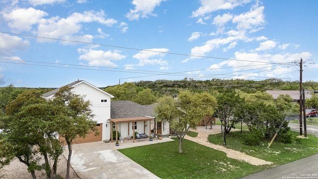 1420 Persimmon Pass, Fischer, TX 78623 - view of front of house with driveway, a front yard, and a garage