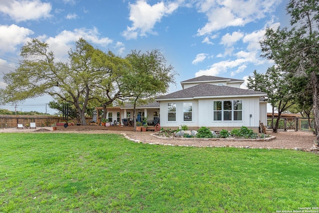 1420 Persimmon Pass, Fischer, TX 78623 - back of property featuring a lawn, fence, and a shingled roof