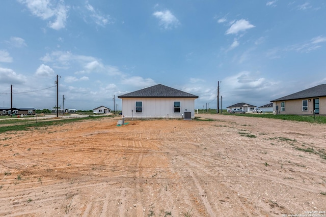 back of house featuring central AC unit