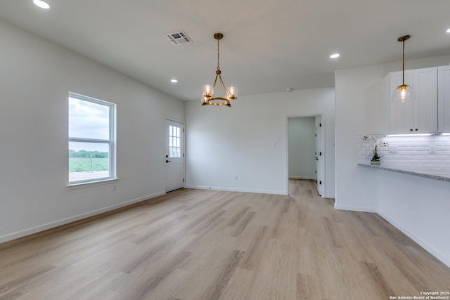 interior space with recessed lighting, a notable chandelier, visible vents, and light wood finished floors