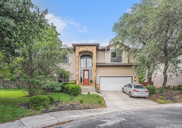 view of front of property with fence, an attached garage, stucco siding, a front yard, and concrete driveway