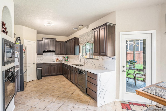 kitchen featuring dark brown cabinetry, decorative backsplash, a sink, and black appliances