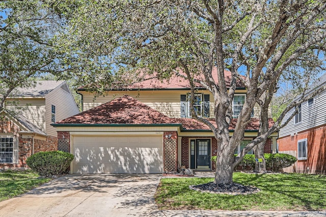 traditional-style house featuring an attached garage, driveway, a front lawn, and brick siding