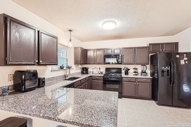 kitchen with pendant lighting, a peninsula, a textured ceiling, a sink, and black appliances