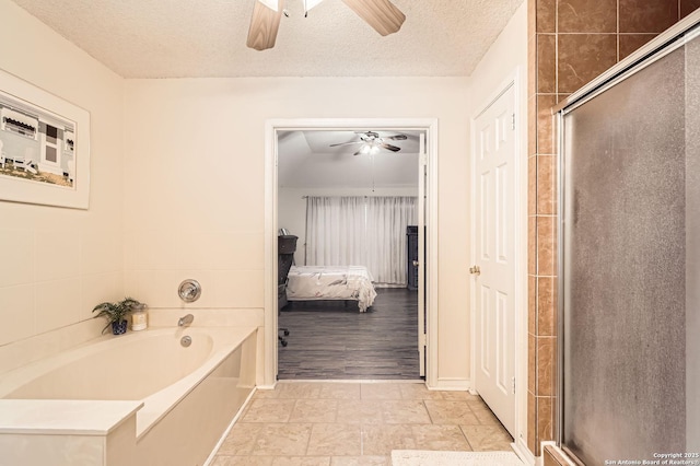 full bath with a ceiling fan, a textured ceiling, ensuite bathroom, and a bath