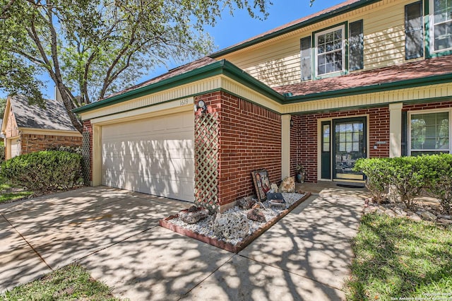 view of front of property with a porch, brick siding, an attached garage, and driveway