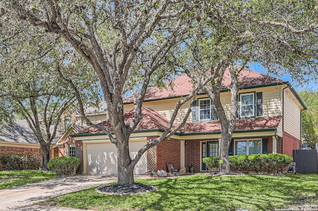view of front of property featuring an attached garage, a front lawn, driveway, and brick siding