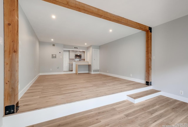 66 Brees Blvd Unit 125, San Antonio, TX 78209 - unfurnished living room featuring recessed lighting, baseboards, visible vents, and light wood-type flooring
