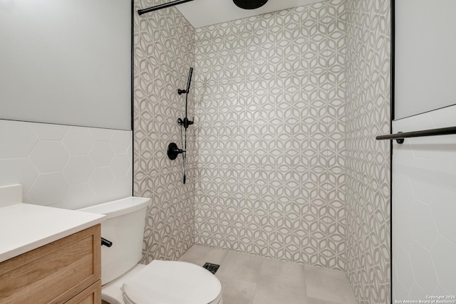 66 Brees Blvd Unit 125, San Antonio, TX 78209 - full bathroom featuring vanity, toilet, tiled shower, and tile walls