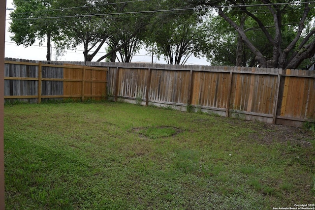 view of yard with a fenced backyard