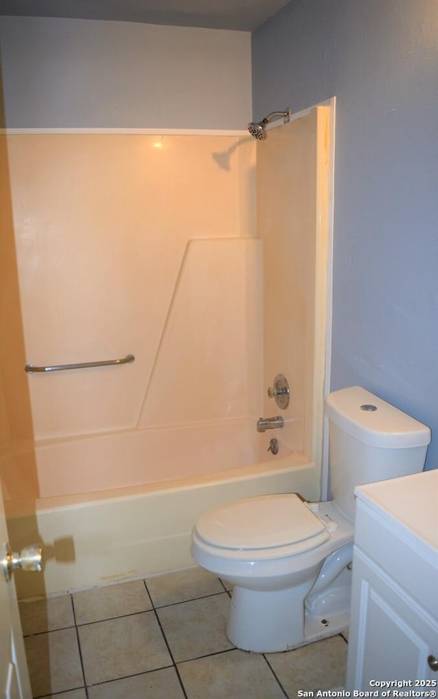 bathroom featuring tile patterned floors, vanity, toilet, and shower / washtub combination