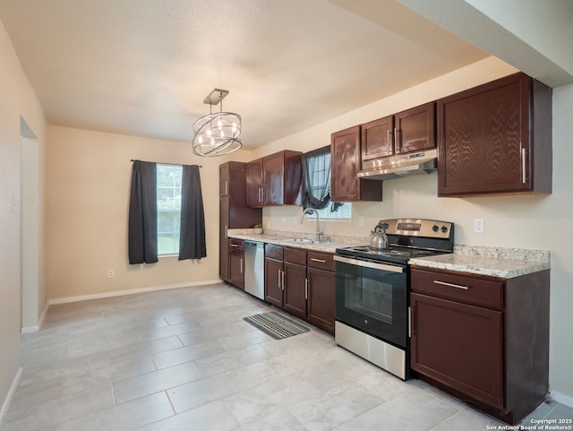 1136 Kentucky Ave, San Antonio, TX 78201 - kitchen with under cabinet range hood, stainless steel appliances, and dark brown cabinetry