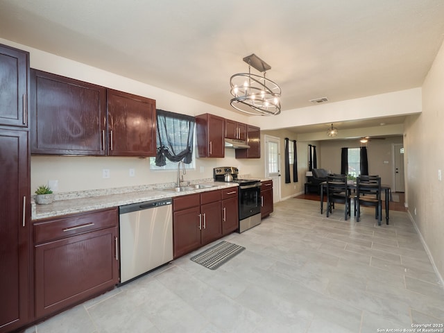 1136 Kentucky Ave, San Antonio, TX 78201 - kitchen with visible vents, appliances with stainless steel finishes, a sink, an inviting chandelier, and under cabinet range hood