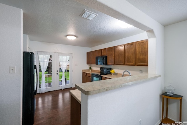 kitchen featuring light countertops, black appliances, french doors, and a textured ceiling