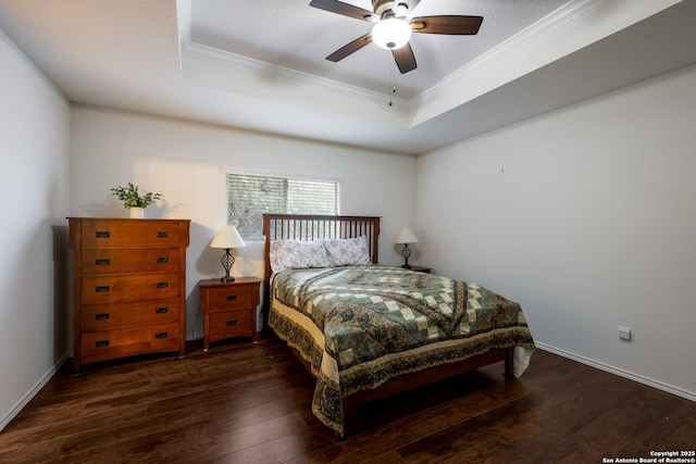 bedroom with crown molding, a raised ceiling, baseboards, and dark wood-type flooring