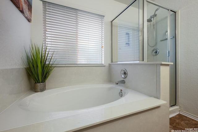 full bath with a shower stall and a bath