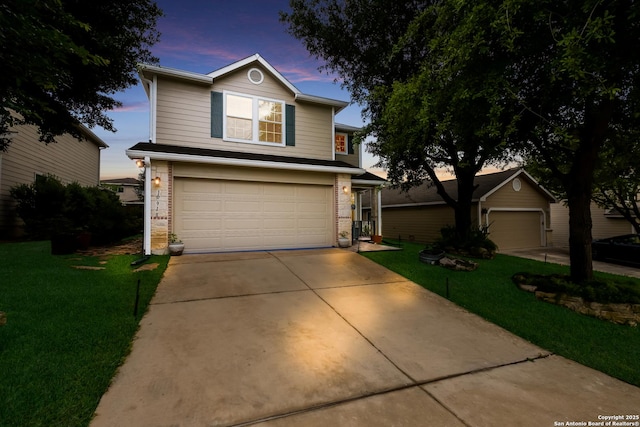 traditional-style house with brick siding, an attached garage, and a front yard