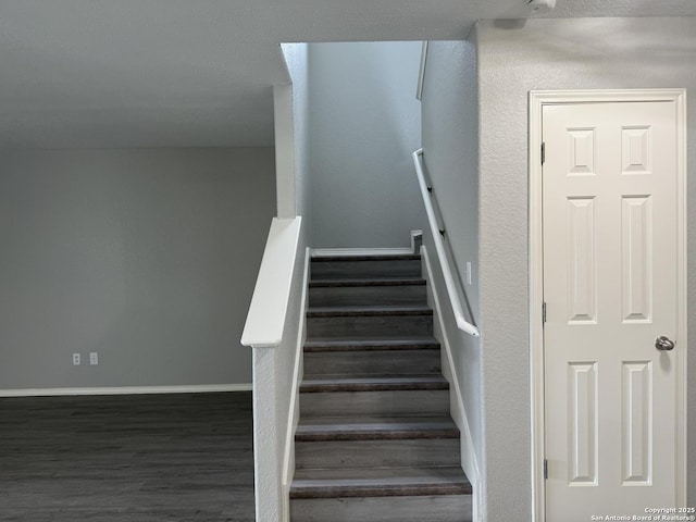 stairs with baseboards and wood finished floors