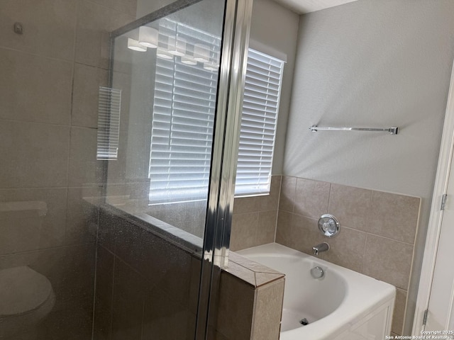 full bathroom with a stall shower and a bath