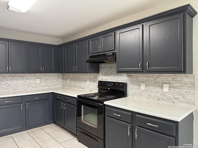 kitchen with under cabinet range hood, electric range, light tile patterned floors, and backsplash