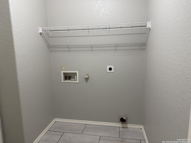 clothes washing area with laundry area, electric dryer hookup, hookup for a gas dryer, tile patterned floors, and hookup for a washing machine