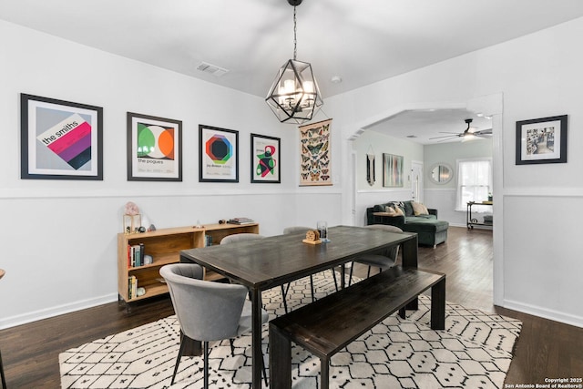 dining room with baseboards, visible vents, and wood finished floors