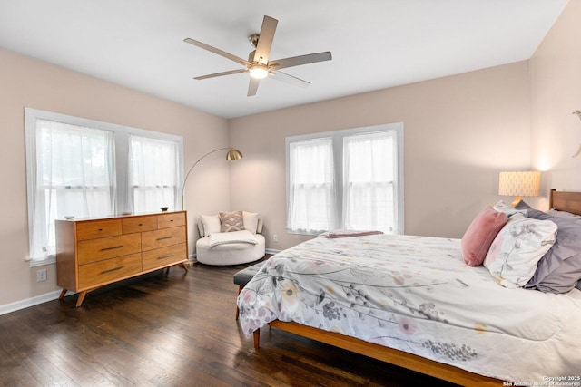 bedroom with baseboards, dark wood finished floors, and ceiling fan