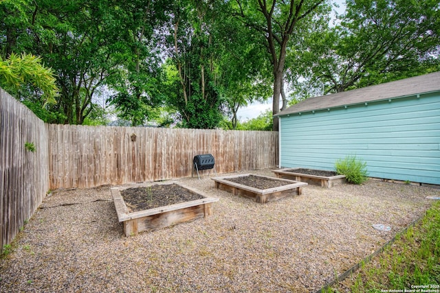 view of yard with a fenced backyard and a vegetable garden