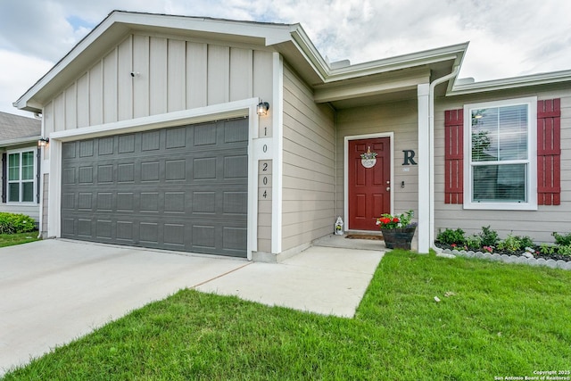 single story home featuring board and batten siding, an attached garage, concrete driveway, and a front yard