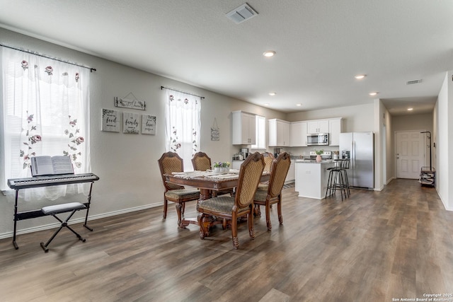 dining space with visible vents, recessed lighting, and dark wood-style flooring