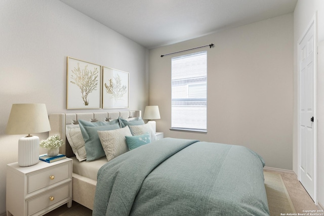 bedroom featuring baseboards and carpet flooring