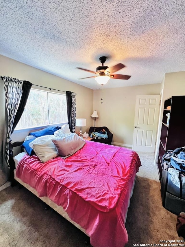 carpeted bedroom featuring ceiling fan and a textured ceiling