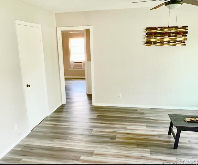 667 Ellor, San Antonio, TX 78228 - spare room with baseboards, a ceiling fan, wood finished floors, and cooling unit