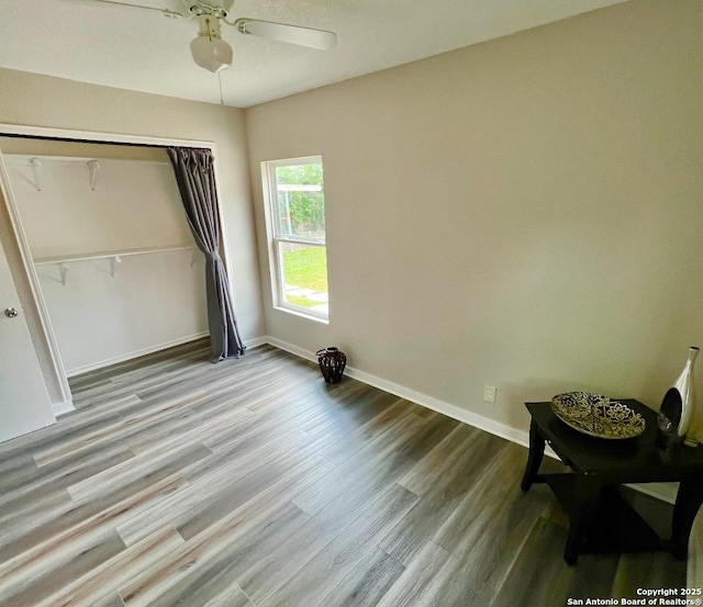 667 Ellor, San Antonio, TX 78228 - unfurnished bedroom featuring a ceiling fan, baseboards, wood finished floors, and a closet
