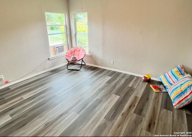 667 Ellor, San Antonio, TX 78228 - interior space featuring baseboards, a textured wall, cooling unit, and wood finished floors