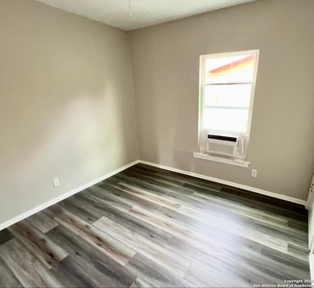 667 Ellor, San Antonio, TX 78228 - empty room with baseboards, cooling unit, and dark wood-type flooring