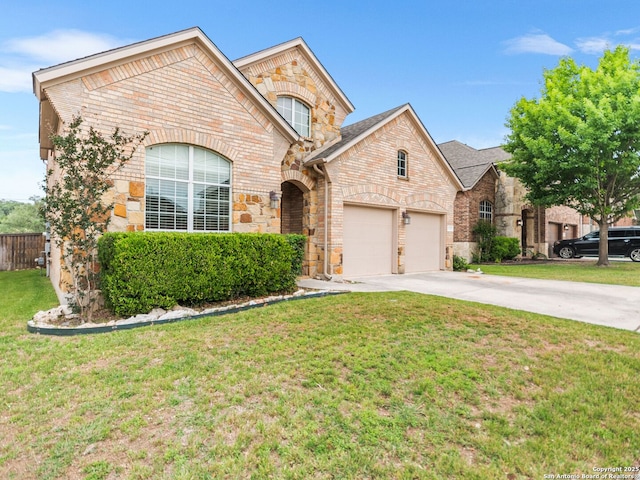 french country home with brick siding, driveway, stone siding, and a garage