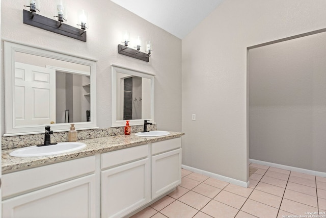 full bath featuring a sink, tile patterned floors, and vaulted ceiling