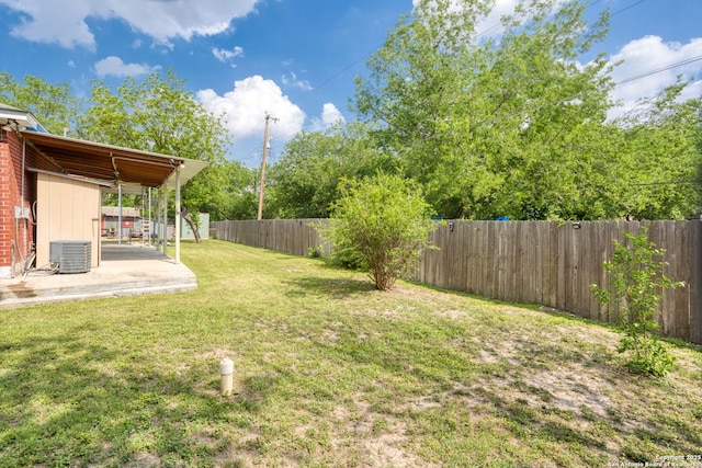 view of yard featuring a fenced backyard, a patio area, and central AC