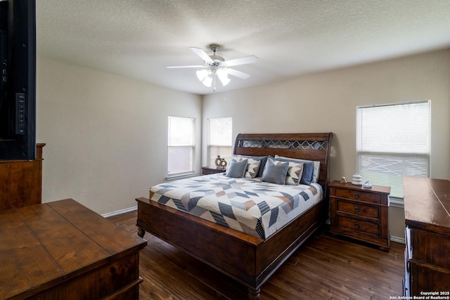 bedroom featuring baseboards, a ceiling fan, a textured ceiling, and dark wood-type flooring