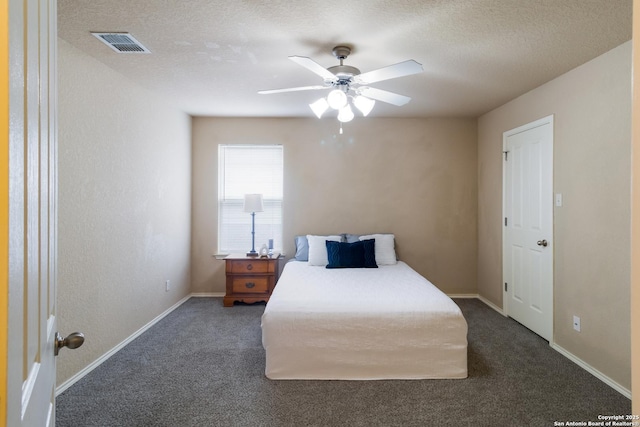carpeted bedroom featuring a ceiling fan, baseboards, visible vents, and a textured ceiling
