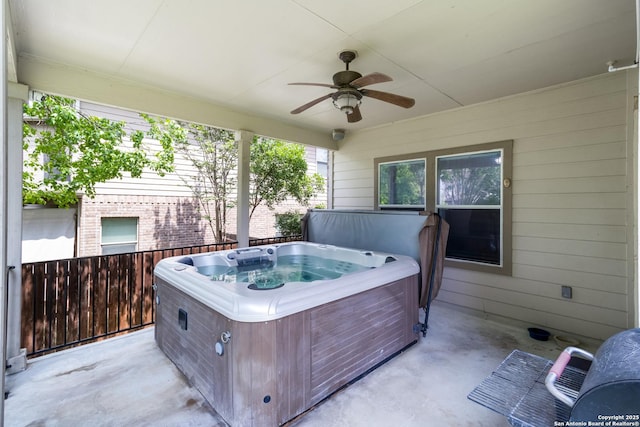 view of patio featuring ceiling fan and a hot tub