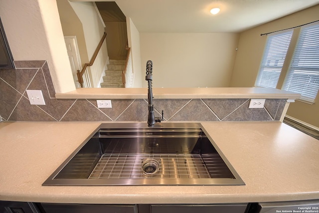 details with light countertops, a sink, and tasteful backsplash