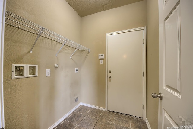 clothes washing area featuring dark tile patterned floors, hookup for an electric dryer, laundry area, baseboards, and hookup for a washing machine
