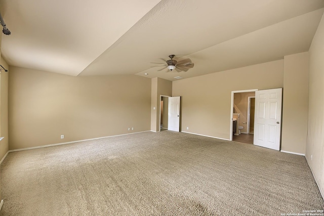 carpeted spare room with baseboards, vaulted ceiling, and ceiling fan